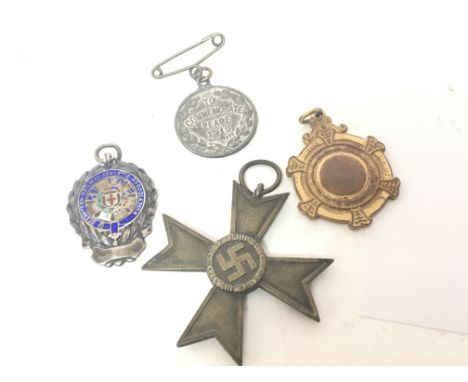 A German Third Reich Merit cross an enamel and silver Railway Association medal and two other medals (4)