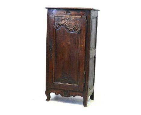 A 19th Century French carved oak side cupboard
The carved shaped fielded panel door enclosing shelves, raised on shape feet, 