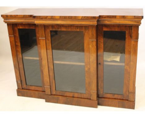 A good quality Victorian rosewood breakfront credenza
Fitted with three glazed panel full length doors, the central door with