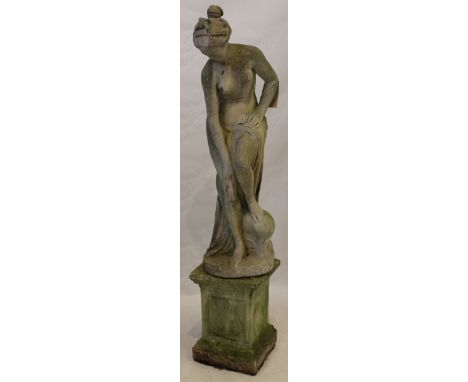 After the Antique, a reconstituted stone garden statute, 20th Century
Depicting a semi naked classical maiden, raised on plin