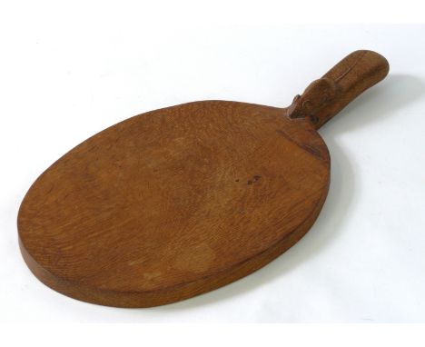 A Robert Mouseman Thompson cheese board of oval form
Having adzed decoration, length 40cm.
