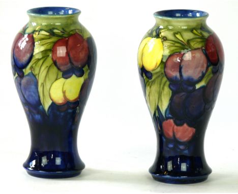 A Pair of Walter Moorcroft pottery vases of inverted baluster form
Decorated in the Wisteria pattern on a light green and blu