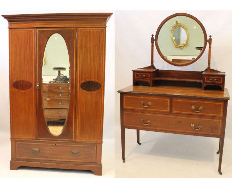 An Edwardian inlaid mahogany bedroom pair
The wardrobe with moulded cornice above oval bevelled mirrored central door, enclos