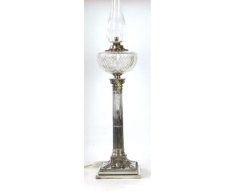 A substantial, converted to electricity, silver-plated column oil lamp, early 20th Century 
The Corinthian capital with flute