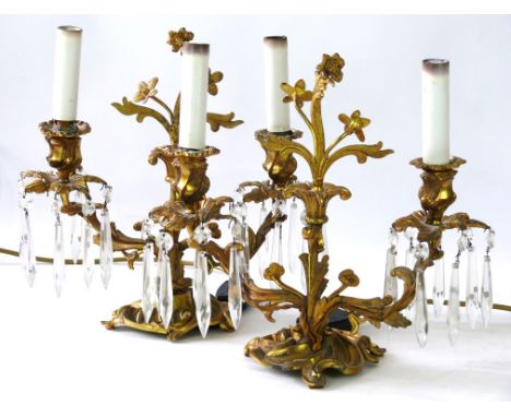 A pair of gilt metal Louis XVIII style light fittings, late 19th/early 20th Century 
Each twin light fitting with glass drops