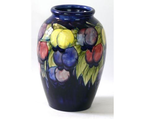 A Walter Moorcroft pottery vase of cylindrical form
Decorated in the Wisteria pattern on a blue ground, blue signature and im