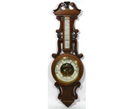 A mahogany framed aneroid barometer, late 19th/early 20th Century 
The ceramic dial marked with Arabic numerals, maker T Henr