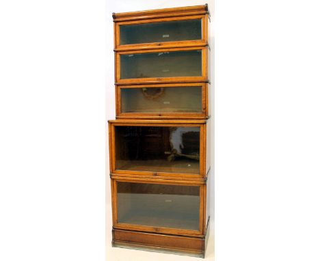 A monumental Globe Wernicke light oak stacking bookcase, circa 1920
The five glazed upper sections above two deeper correspon