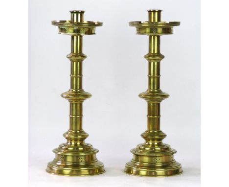 A pair of early 20th Century Pugin style candle holders 
Having pierced and knop decoration, unmarked, height 41cm.
 CONDITIO