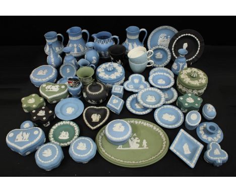 A Wedgwood Jasperware powder bowl and cover, jugs, trinket dishes, candlestick, vases, sucrier and cover, in powder blue, sea