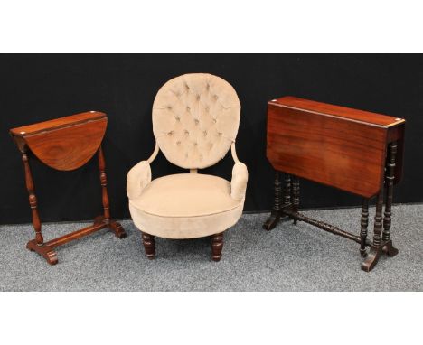 An Edwardian mahogany Sutherland table; another, smaller, later; an Edwardian button-back nursing chair (3)