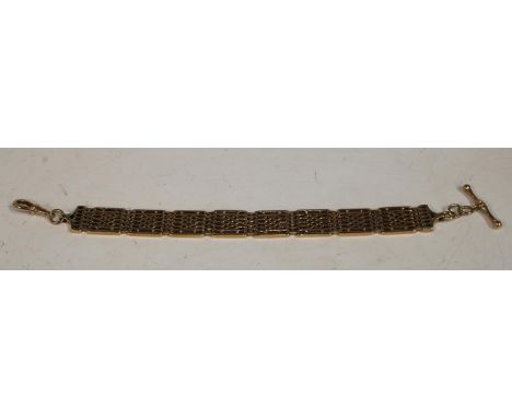 An ornate yellow metal link gate bracelet, Tbar hook clasp, indistinctly marked, (tests as 9ct gold), 20cm long, 13mm wide, 3