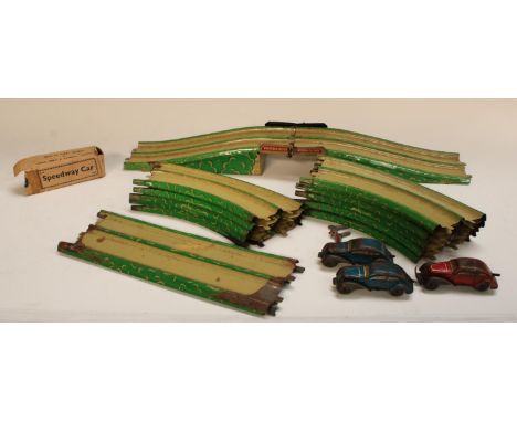 A Streamline Speedway racing set by Louis Marx &amp; Co.Ltd comprising tin twin lane figure of eight bridged track, two clock