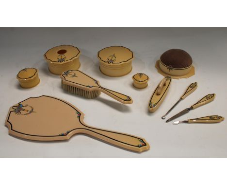 A lady's Art Deco faux ivory dressing table set, comprising hand mirror, hair brush, pin cushion, manicure set, hair tidy, tr