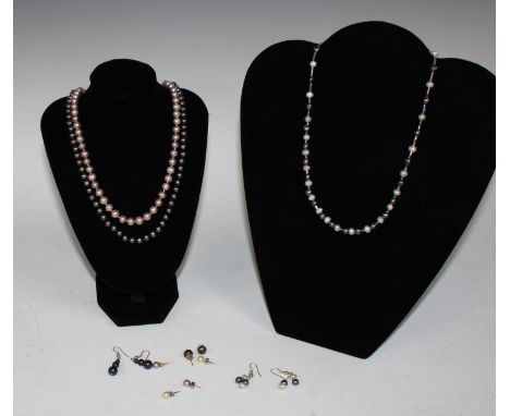 A cultured white and black pearl necklace; other single strand cultured pearl necklaces, black and pink; similar pair of earr
