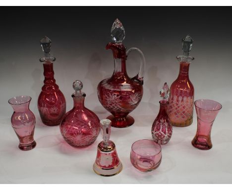 A large Bohemian ruby flashed clear glass single handled jug, faceted drop in stopper, 39cm high; others similar ruby flashed