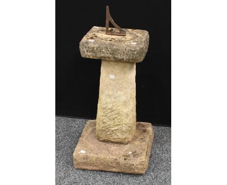 A reconstituted stone garden sundial, the gnomon fashioned from a bracket, 63cm high excluding gnomon