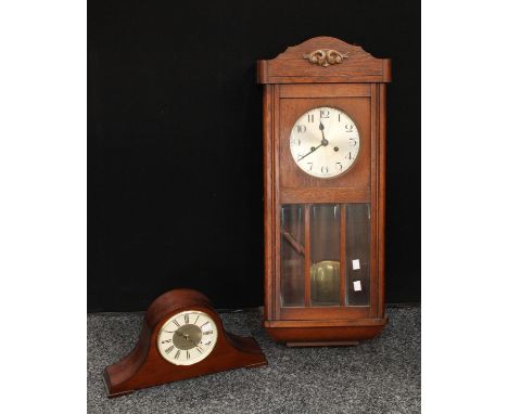 An oak wall clock, eight day, key and pendulum, 80cm; a London Clock Company mahogany mantel clock, Westminster chime, batter