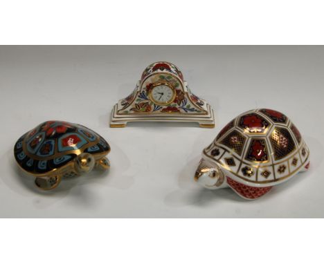 A Royal Crown Derby paperweight, Terrapin, gold stopper; another, Tortoise, silver stopper; a miniature Arita pattern mantel 