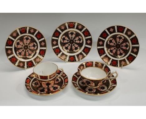 A Royal Crown Derby Imari palette 1128 pattern teacup and saucer; another in a different shape; three Royal Crown Derby 1128 