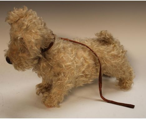 A 1940s Chiltern Toys Stuffed soft Terrier dog,  modelled standing, legs stretching fore and aft, creamy white body, glass ey