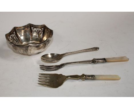 A pierced silver octagonal dish, 89.7g, marked "Silver"; a silver spoon, similar, 36.9g; two silver plated mother-of-pearl pi