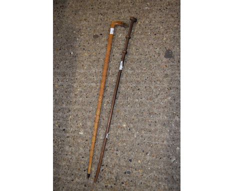 A carved hardwood walking stick with animal style head together with another cane (2)