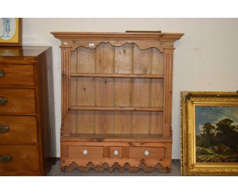 A pine wall shelf with three drawers to base