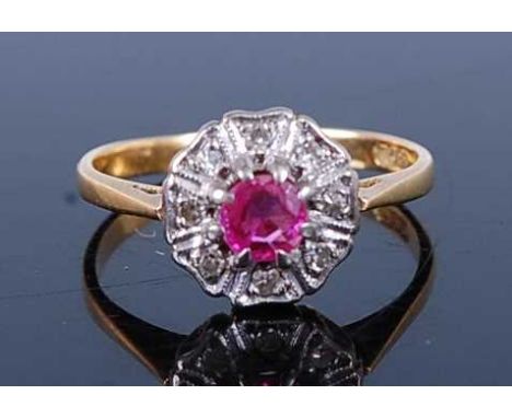 A vintage 18ct gold ruby and diamond flower head cluster ring, the round cut ruby weighing approx. 0.3ct in a surround of 8 s