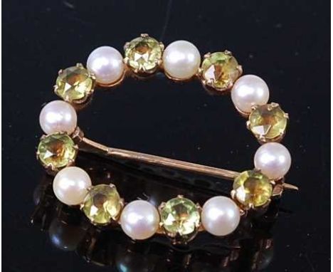 A yellow metal, peridot and pearl circular brooch, featuring eight round faceted peridots alternating with eight approx 3.9 x