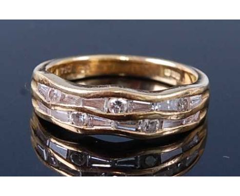 An 18ct yellow gold and diamond two-row half hoop ring, comprising five round brilliant cut diamonds alternating with twelve 