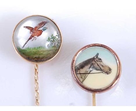 Two yellow metal stick pins, one depicting a reverse crystal image of a pheasant in flight, length 67mm, crystal diameter 15m