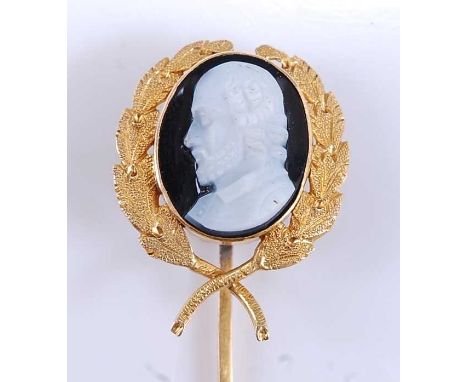 A yellow metal hardstone cameo stick pin, depicting the profile of an Elizabethan gentleman within a laurel leaf surround, ca