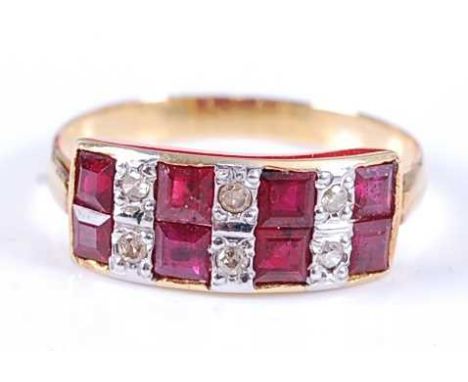 A yellow metal, ruby and diamond two-row half hoop eternity ring, featuring four pairs of square cut rubies alternating with 
