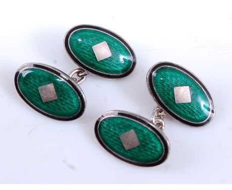 A pair of silver and enamel double-ended cufflinks,  each having two 18 x 11mm oval plates with engine turned green enamel ce