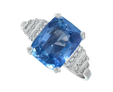 UNHEATED SAPPHIRE AND DIAMOND RING comprising of a cushion cut sapphire of 5.15 carats between rows of round cut diamonds, un