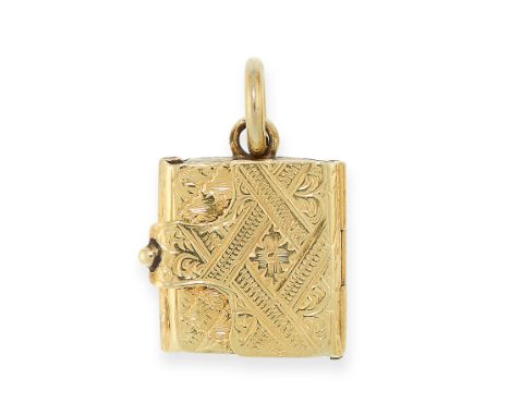 ANTIQUE MOURNING LOCKET BOOK CHARM PENDANT in yellow gold, detailed in textured design, opening to reveal an inner glass cove