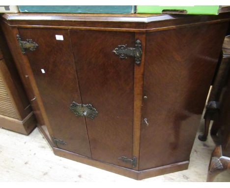 Early to mid 20th Century oak side cabinet with two central panel doors enclosing drawers, flanked by canted panel doors, 130