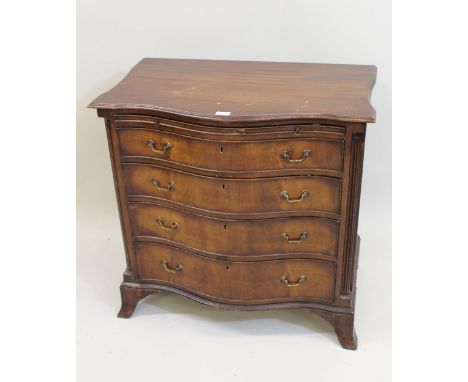Early 20th Century mahogany serpentine fronted dwarf chest with a brushing slide, above four graduated drawers raised on brac