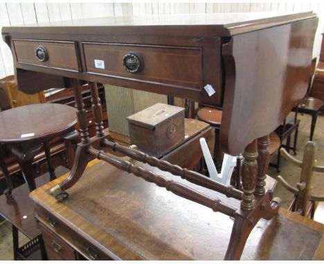 Reproduction mahogany two drawer drop-end sofa table, on turned carved twin end supports with splayed reeded legs, and brass 