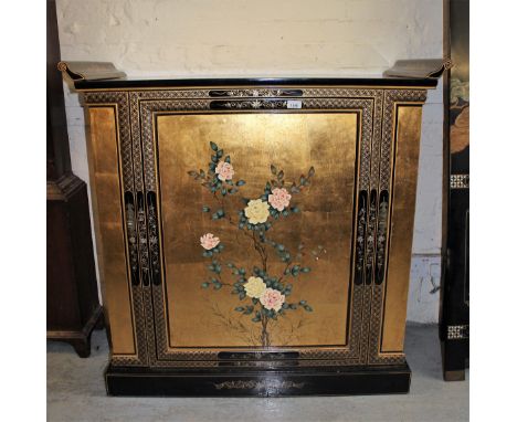 Modern Chinese lacquer side cabinet, the floral decorated top above a conforming panel door, the end panels opening to reveal