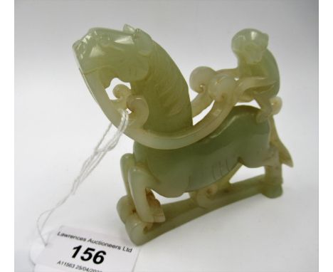 Carved pale green jade group of a monkey riding a horse, 8.5cm x 9cm approximately 