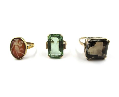 Large smoky quartz single stone ring, a similar green stone ring and shell cameo ring 