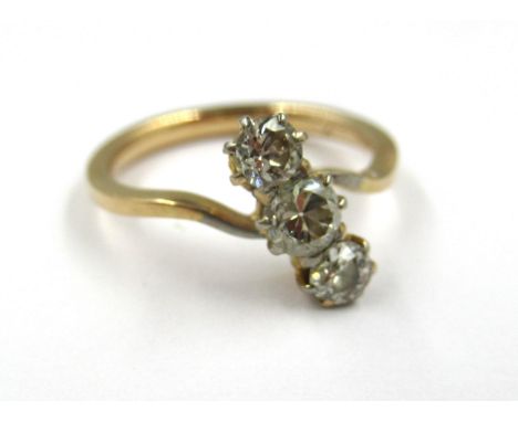 Yellow gold three stone diamond set crossover ring (marks rubbed), size J 