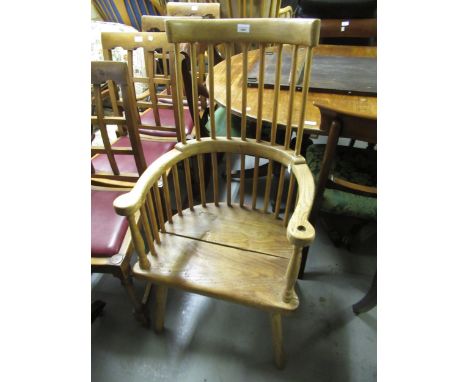 Oak and elm comb back armchair on splay supports 