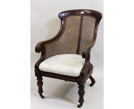 Early Victorian mahogany tub shaped bergere armchair, the scroll carved arms above a button upholstered cushion and cane seat