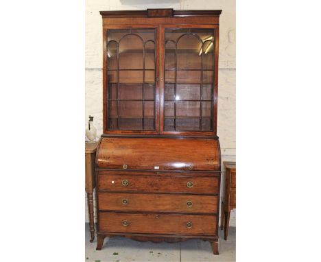 Regency mahogany and black line inlaid cylinder bureau bookcase, the moulded cornice above a pair of bar glazed doors enclosi