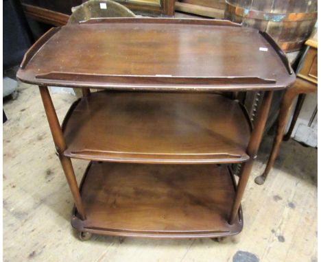 Ercol three tier dark stained tea trolley on casters, 77cms high x 47cms deep x 72cms wide 