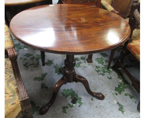 19th Century flame mahogany circular tilt top pedestal table on turned tapering column with tripod base and claw and ball fee