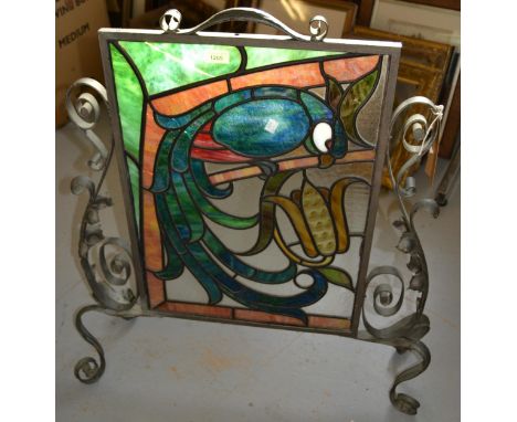 Wrought iron firescreen with coloured , leaded glass panel decorated with a parrot (glass cracked), together with a similar t